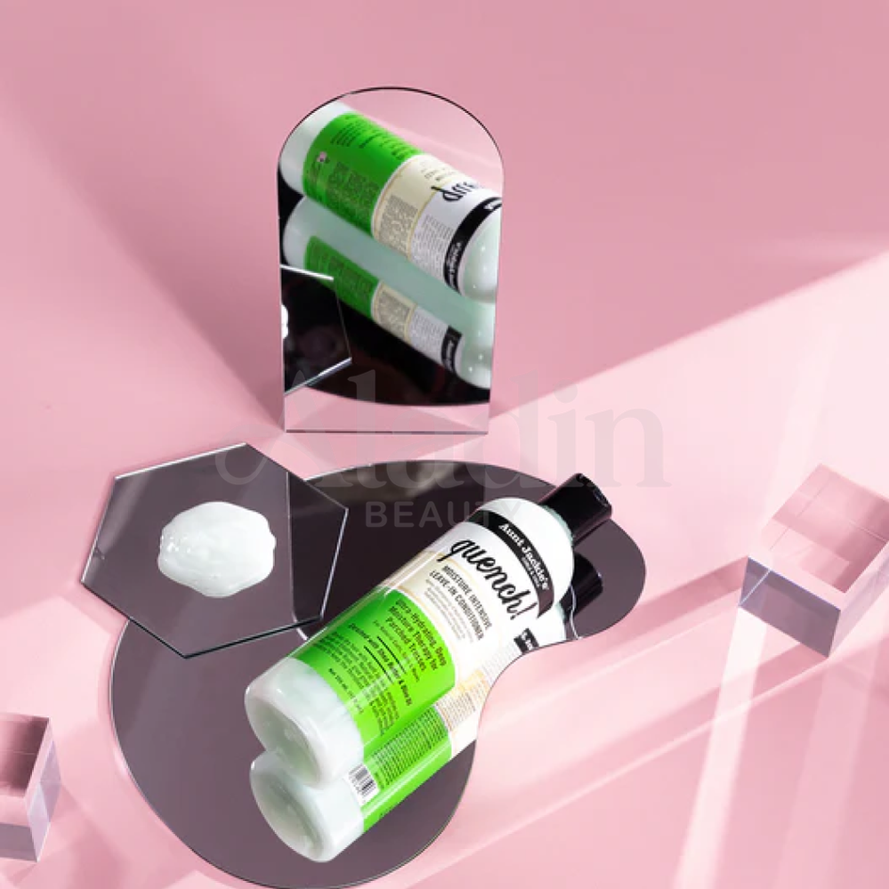 Aunt Jackie's Quench! Leave-In Conditioner, white bottle with green label, on mirrors with a product swatch.