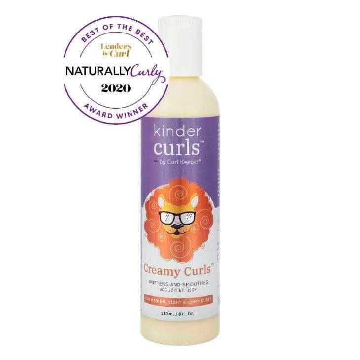 Curl Keeper Kinder Creamy Curls hair moisturizer in a white bottle with a purple label and lion graphic, featuring a "NaturallyCurly 2020 Award Winner" seal.
