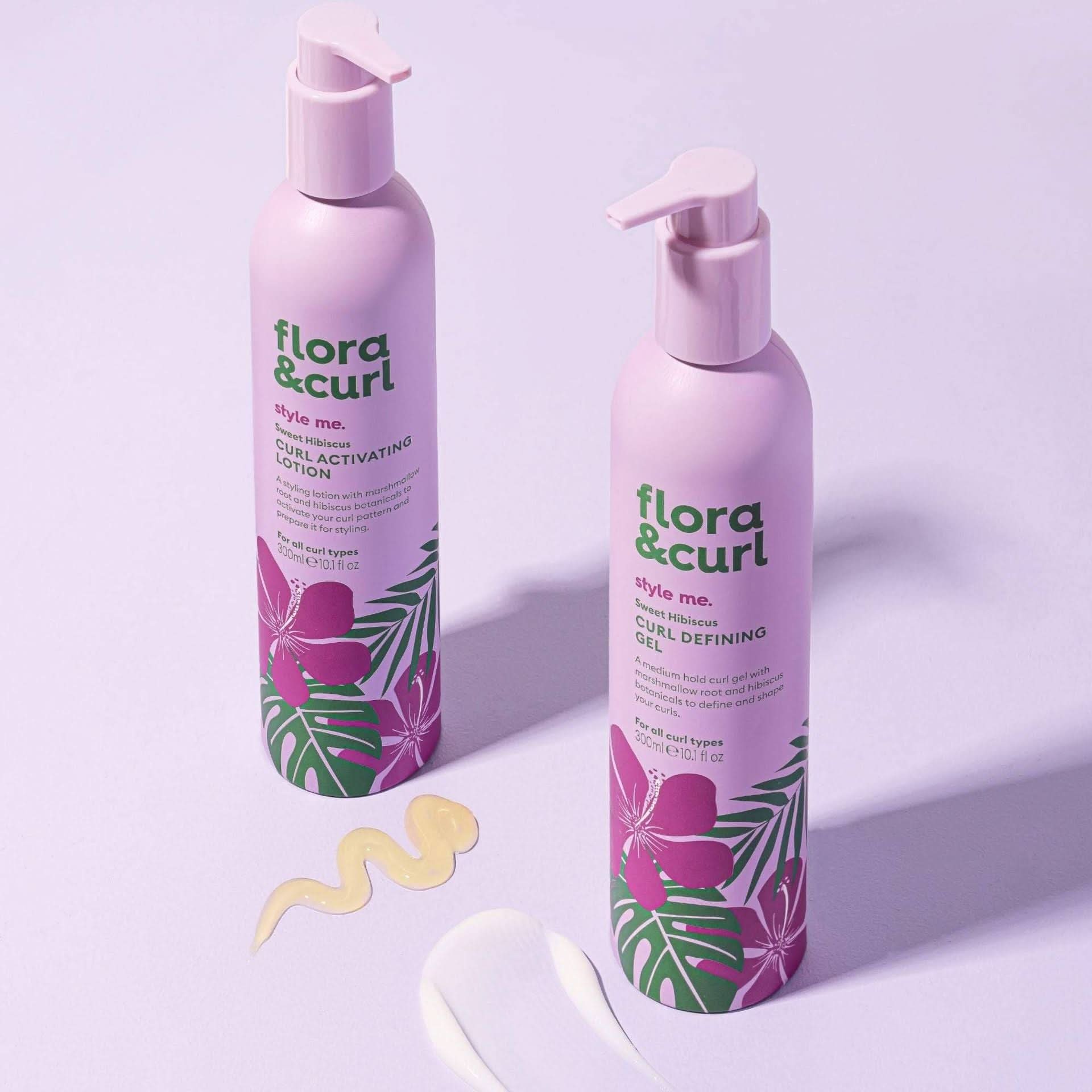 Two pink Flora & Curl bottles with hibiscus design, one curl activating lotion, one curl defining gel, with product swatches.