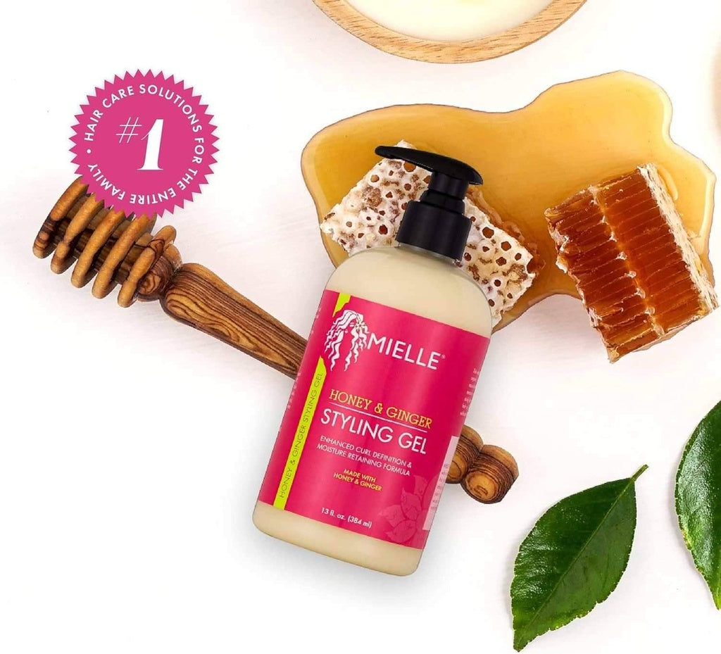 Mielle Honey & Ginger Styling Gel 384ml pump bottle with honeycomb, honey dipper, and green leaves.